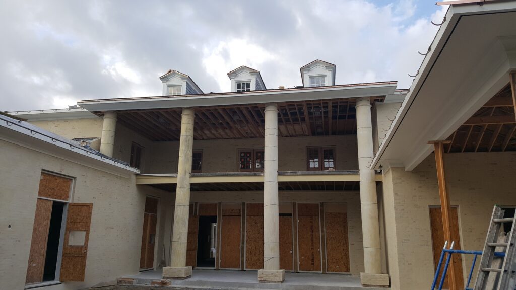 A building with columns and windows under construction.