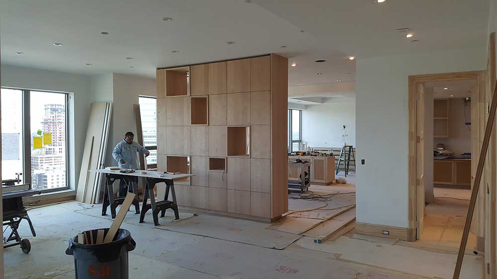 A room being remodeled with wood paneling and walls.