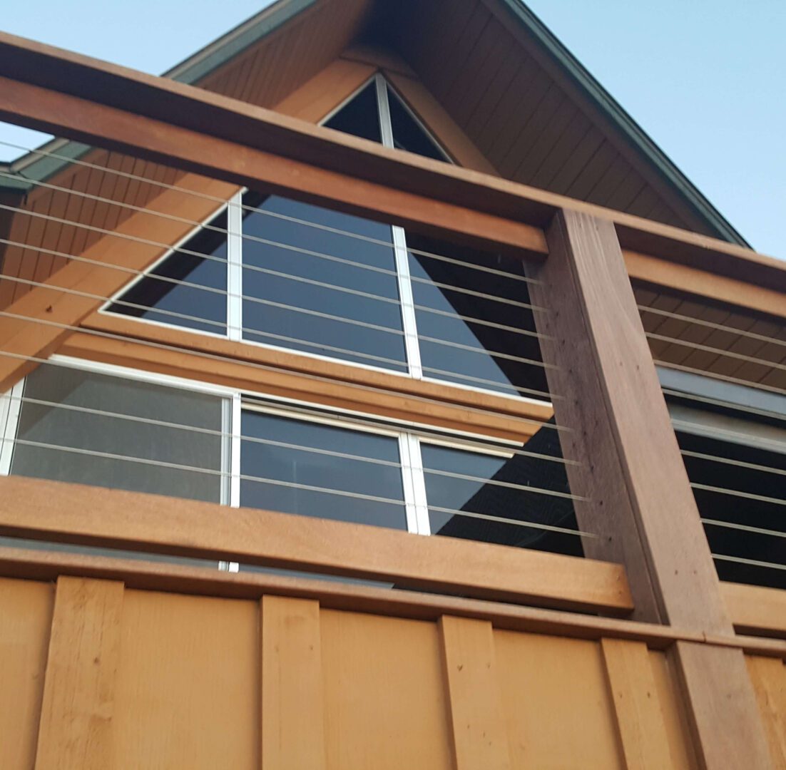 A wooden structure with a metal railing on the side.