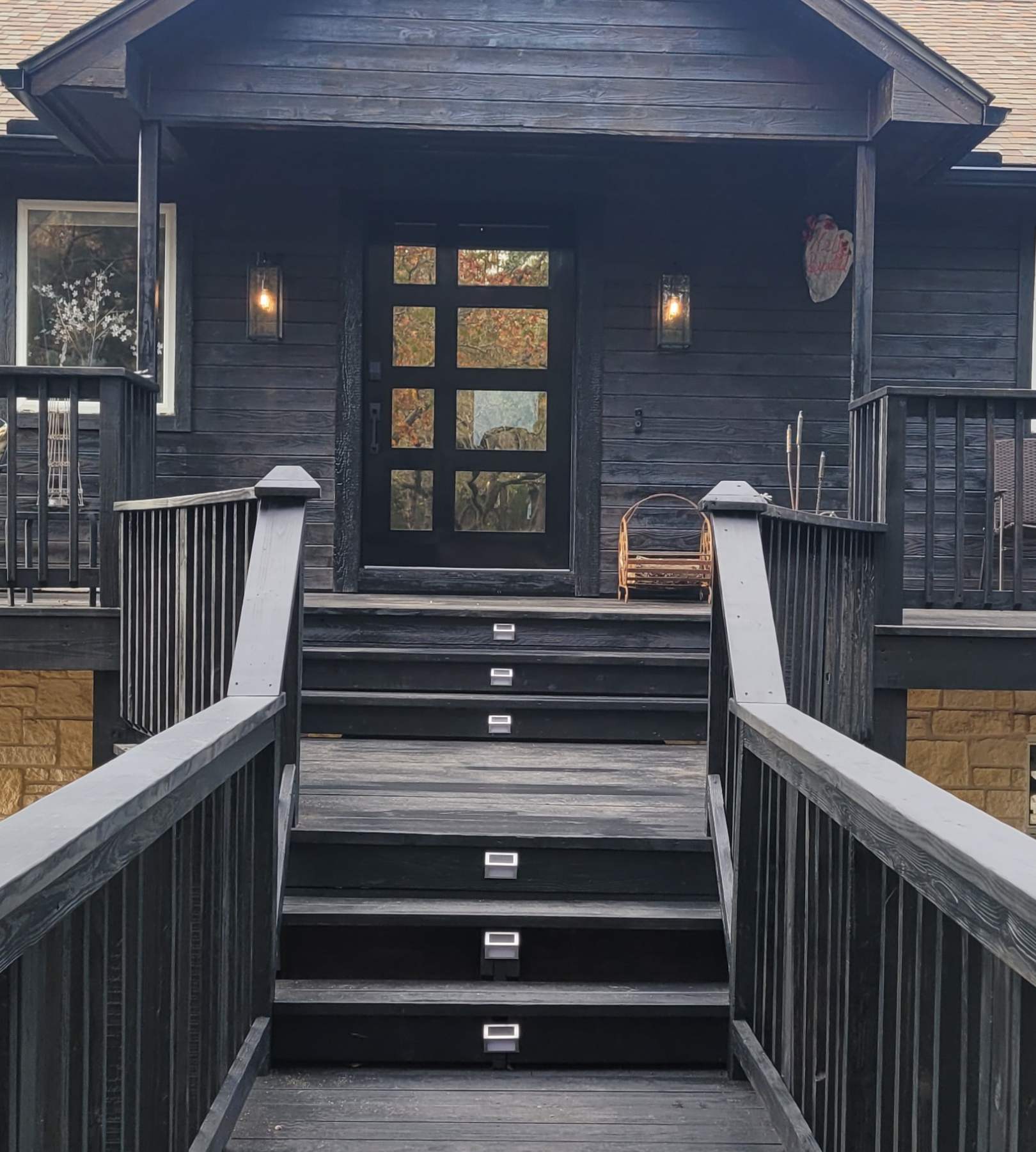 A wooden staircase leading to the front door of a house.