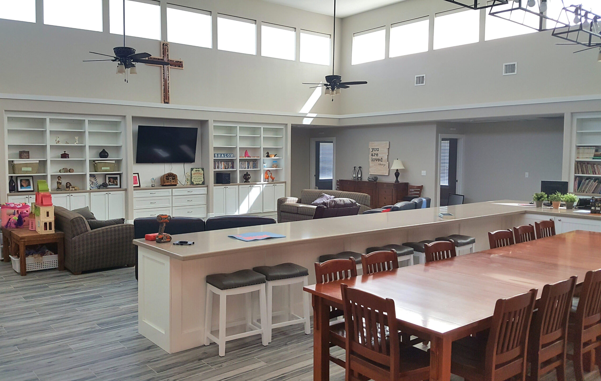 A large open room with a bar and kitchen.